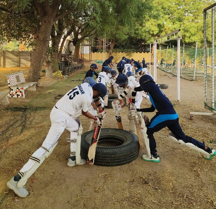 Kids cricket training warm-up session at GRP Sports Academy