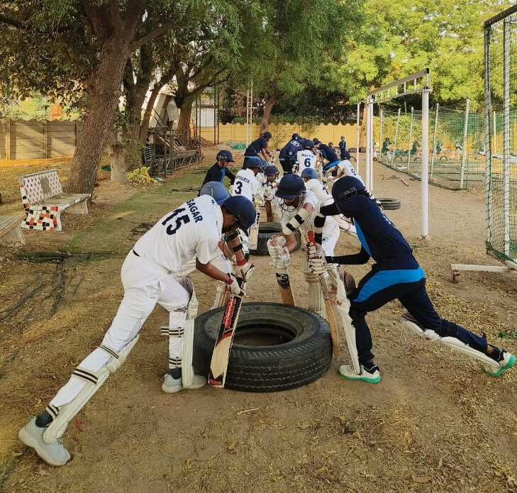 Kids cricket training warm-up session at GRP Sports Academy